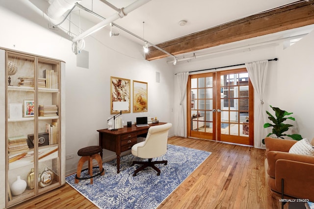 office with light wood finished floors, french doors, beamed ceiling, and rail lighting