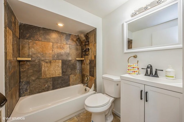 full bathroom with tiled shower / bath, vanity, and toilet