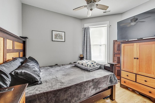 bedroom featuring visible vents, ceiling fan, and light wood finished floors