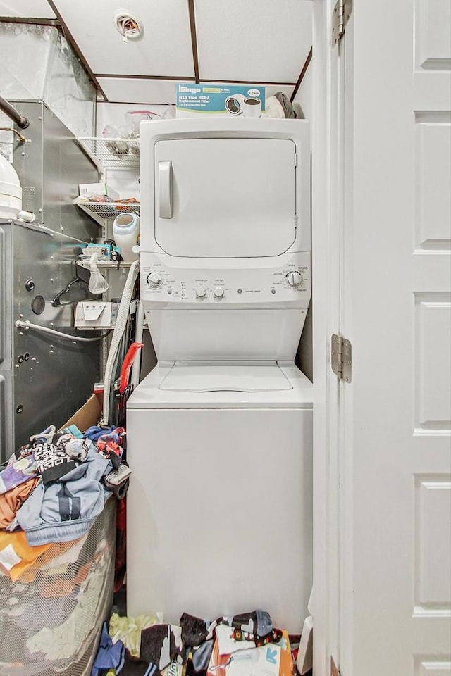 laundry area featuring stacked washing maching and dryer and laundry area