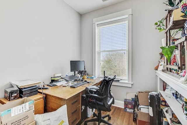 home office featuring baseboards and wood finished floors