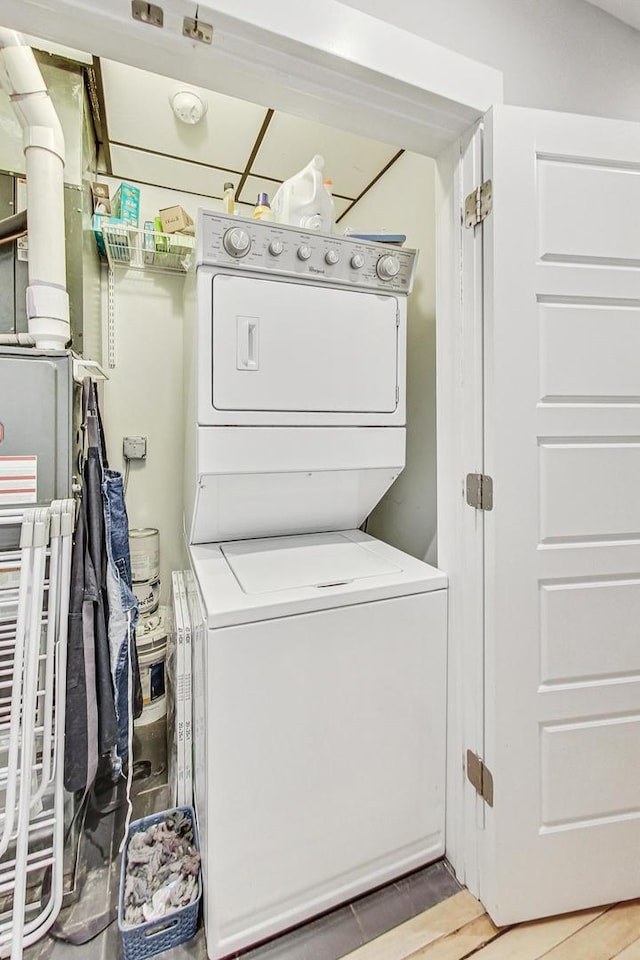 laundry room with stacked washer and dryer and laundry area