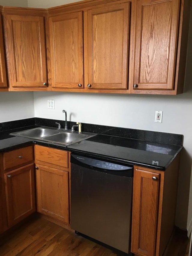 kitchen with dishwashing machine, sink, and dark wood-type flooring