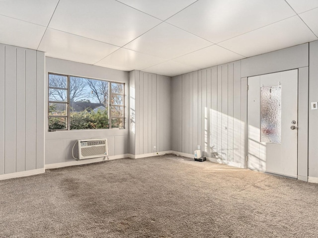 carpeted spare room featuring a wall unit AC