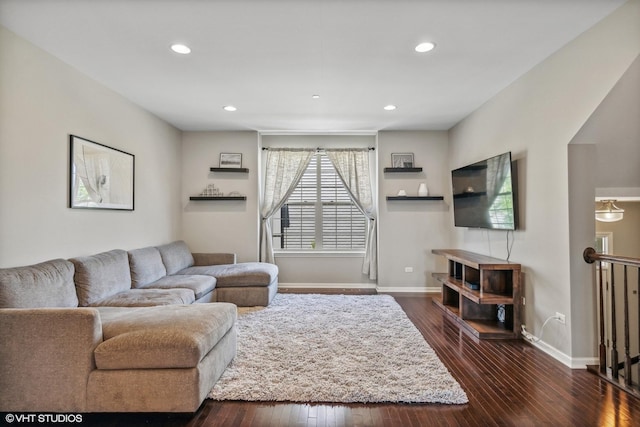 living area featuring recessed lighting, dark wood finished floors, and baseboards