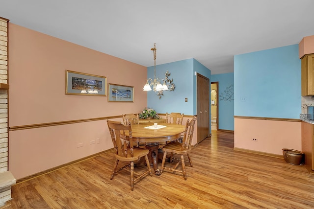 dining area featuring an inviting chandelier and light wood-type flooring