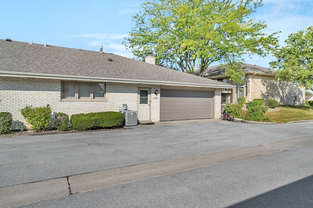 view of front of home with cooling unit and a garage