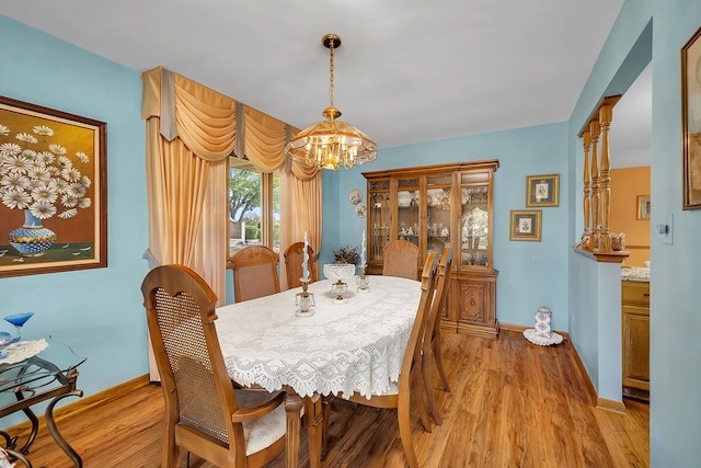 dining space featuring a chandelier and light hardwood / wood-style flooring