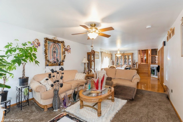 carpeted living room featuring ceiling fan