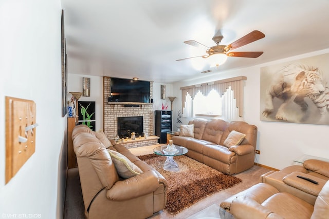 carpeted living room featuring a brick fireplace and ceiling fan