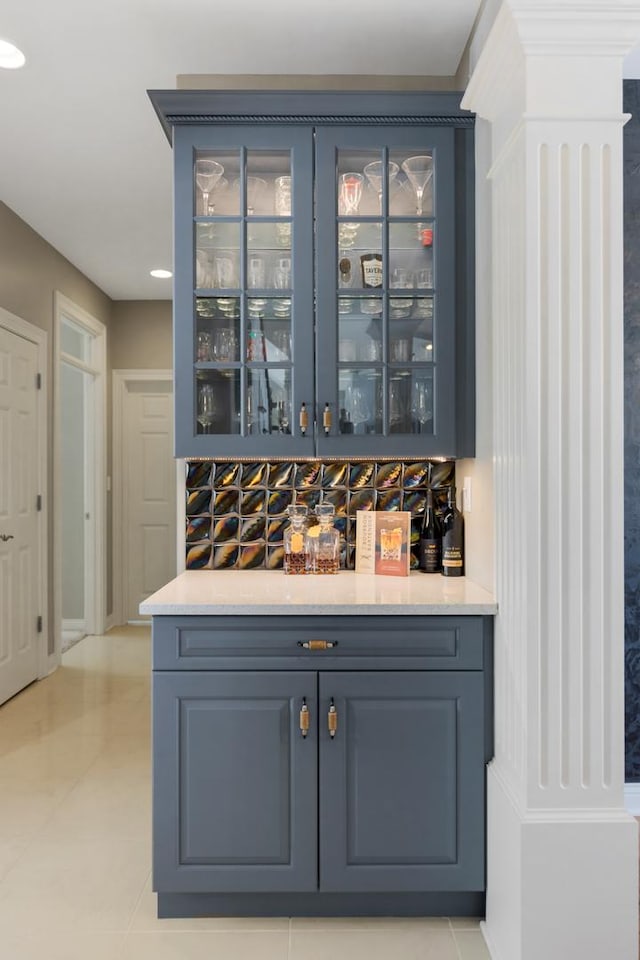 bar featuring a bar and light tile patterned flooring