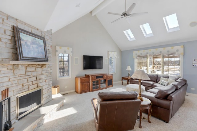 living area with baseboards, light colored carpet, beamed ceiling, a fireplace, and high vaulted ceiling