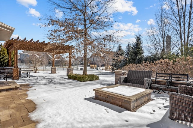 snow covered patio with a pergola