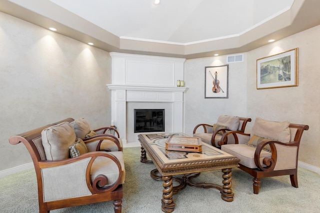 living area featuring carpet floors, baseboards, a fireplace, and visible vents