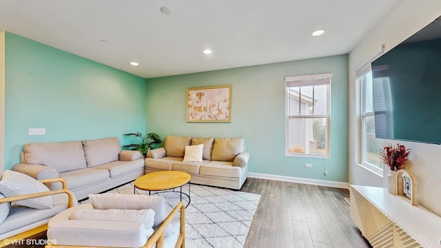 living room featuring wood finished floors, baseboards, and recessed lighting