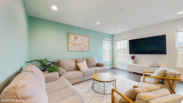 living room featuring recessed lighting, baseboards, and wood finished floors