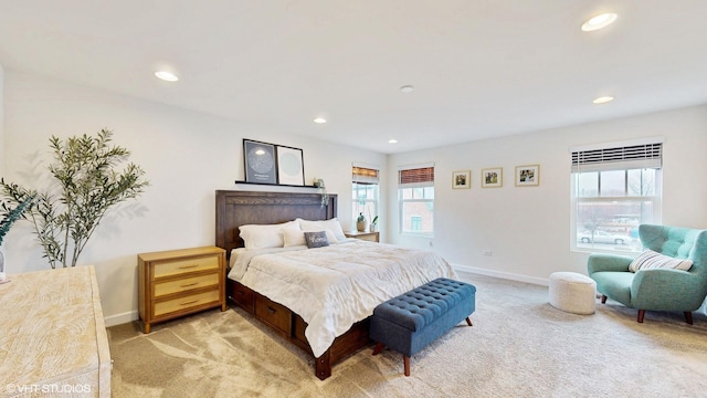 bedroom featuring baseboards, recessed lighting, and light carpet