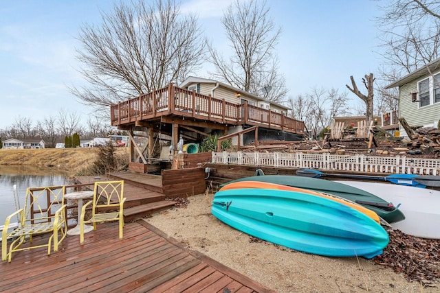 exterior space featuring a deck with water view