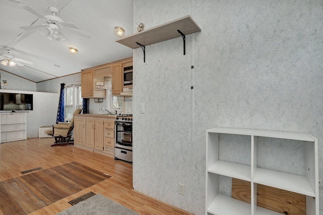 kitchen featuring ceiling fan, light brown cabinets, light wood-style flooring, vaulted ceiling, and stainless steel electric range oven