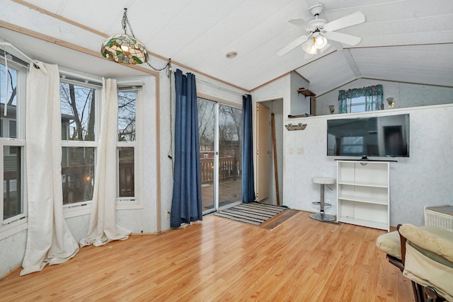 interior space with lofted ceiling, ceiling fan, and wood finished floors