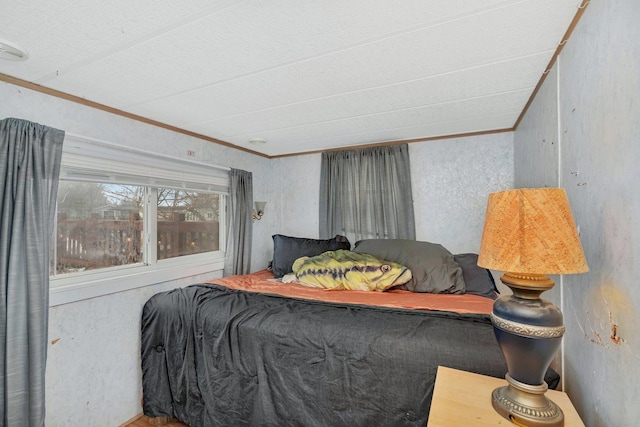 bedroom with a textured wall and crown molding