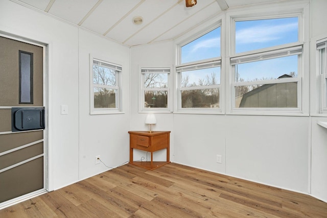 unfurnished sunroom with lofted ceiling