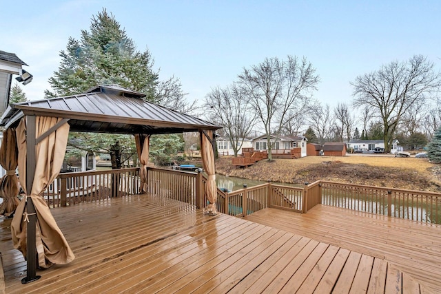 deck with a water view and a gazebo