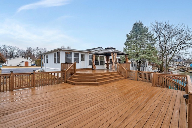 wooden terrace featuring a gazebo