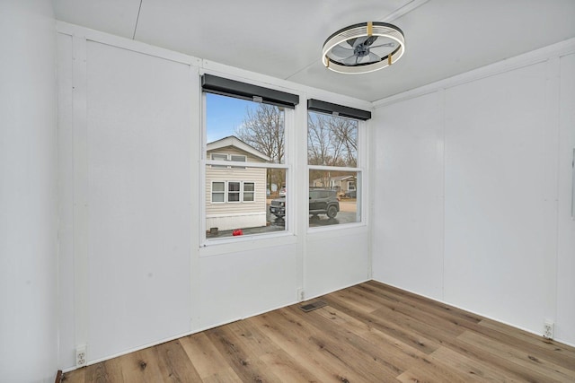 spare room with visible vents and wood finished floors