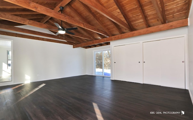 interior space featuring ceiling fan, dark hardwood / wood-style floors, vaulted ceiling with beams, and wood ceiling