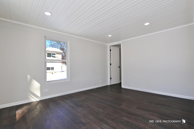 spare room featuring dark wood-type flooring and ornamental molding