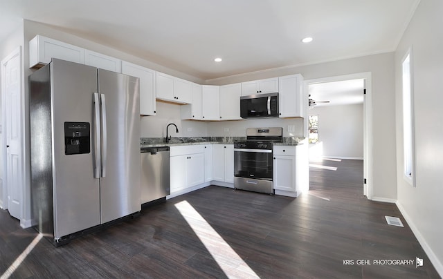 kitchen with light stone countertops, white cabinets, and appliances with stainless steel finishes