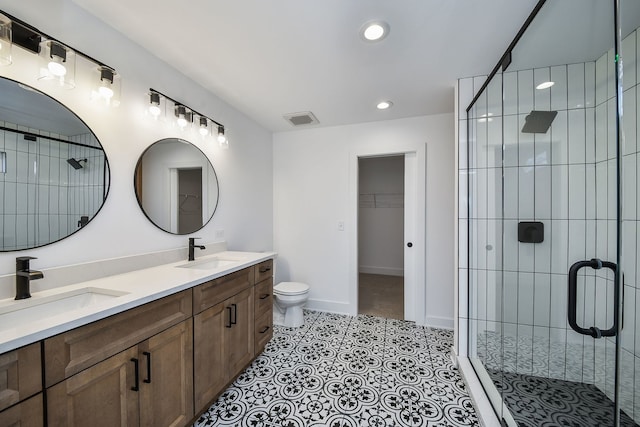 bathroom featuring tile patterned flooring, vanity, walk in shower, and toilet