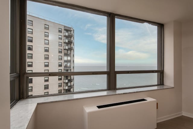 interior space with a water view and radiator heating unit