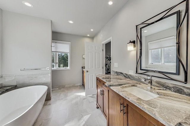 627 68th St, Willowbrook, IL 60527 - full bath with recessed lighting, a healthy amount of sunlight, vanity, and a freestanding tub