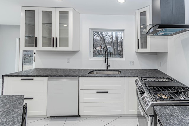 kitchen with white cabinetry, sink, dark stone countertops, dishwashing machine, and stainless steel range with gas stovetop