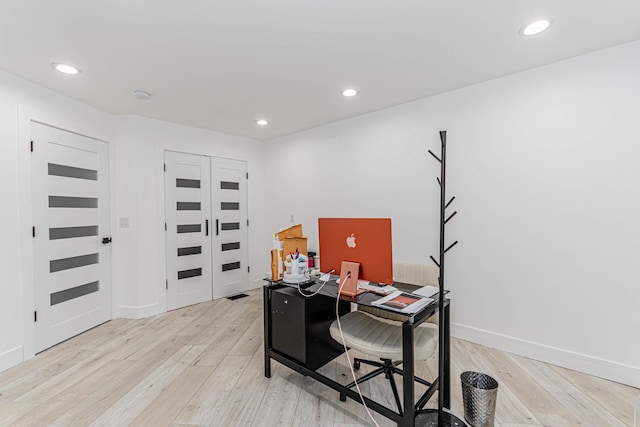 office space with light wood-type flooring