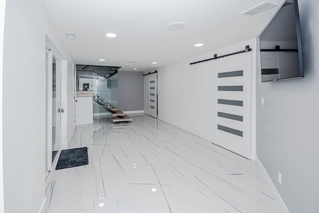 hallway featuring a barn door