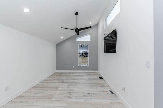 spare room featuring light hardwood / wood-style flooring, ceiling fan, and vaulted ceiling