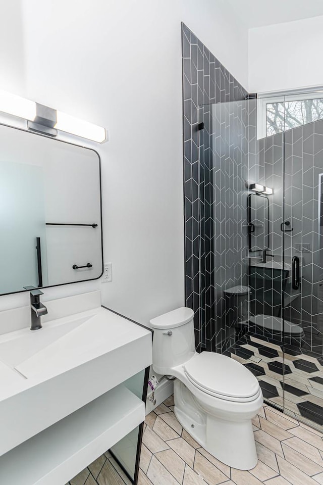 bathroom with vanity, an enclosed shower, and toilet