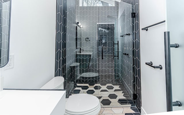 bathroom with tile patterned flooring, toilet, and walk in shower