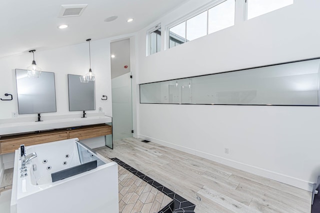 kitchen with hanging light fixtures and light hardwood / wood-style flooring