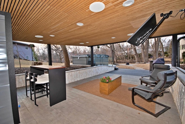 view of patio / terrace with a bar and a jacuzzi