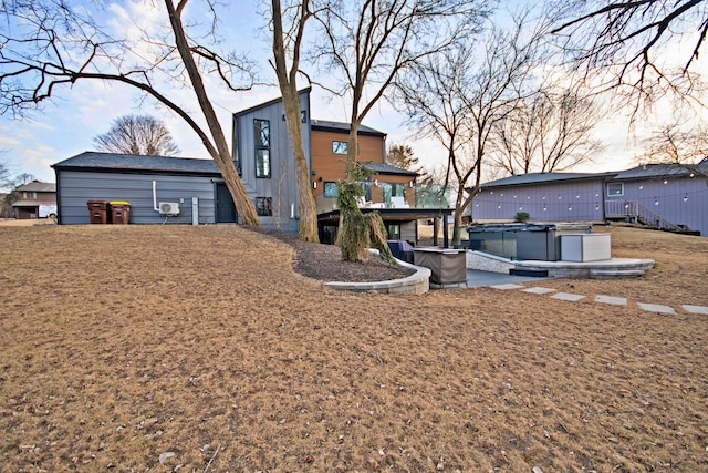 rear view of property with a hot tub