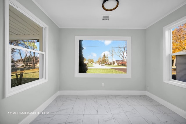 unfurnished room featuring marble finish floor, baseboards, visible vents, and ornamental molding