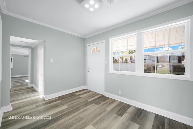 entrance foyer featuring crown molding, baseboards, and wood finished floors