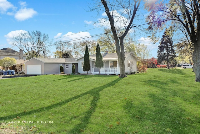 ranch-style home with an attached garage, a porch, a front yard, and aphalt driveway