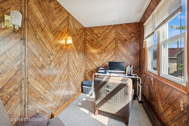 home office with wood walls and carpet flooring