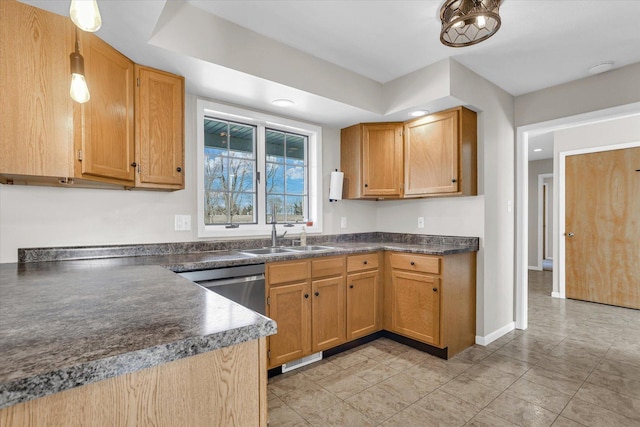 kitchen with a sink, baseboards, dishwasher, dark countertops, and pendant lighting