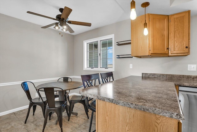 dining room with ceiling fan, baseboards, and light tile patterned floors